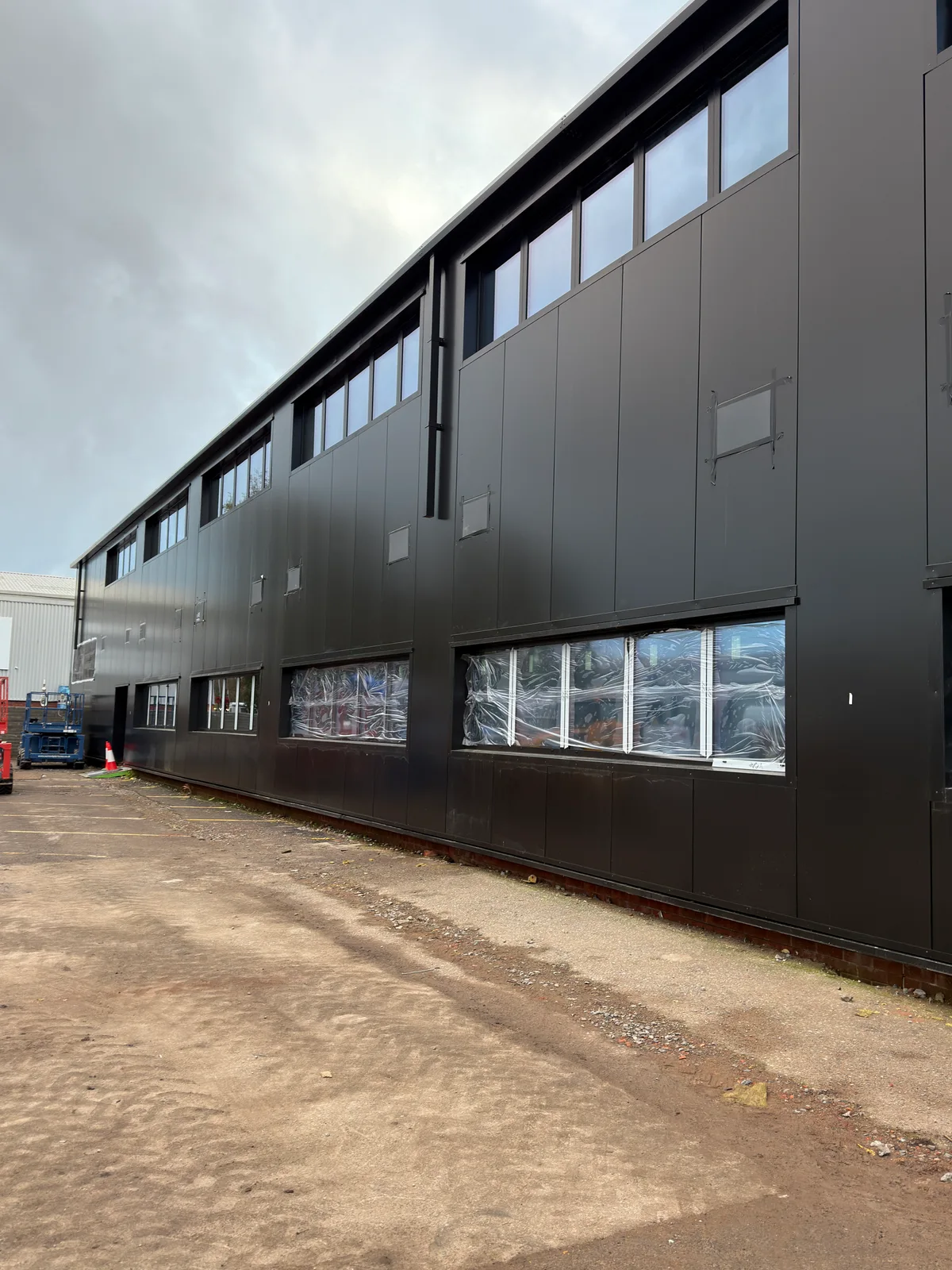 Dark façade panels with high-level windows