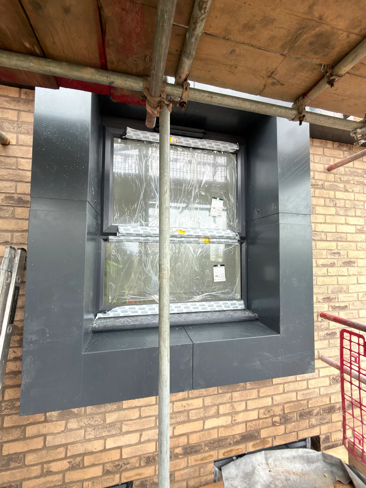 Folded metal window surround during installation